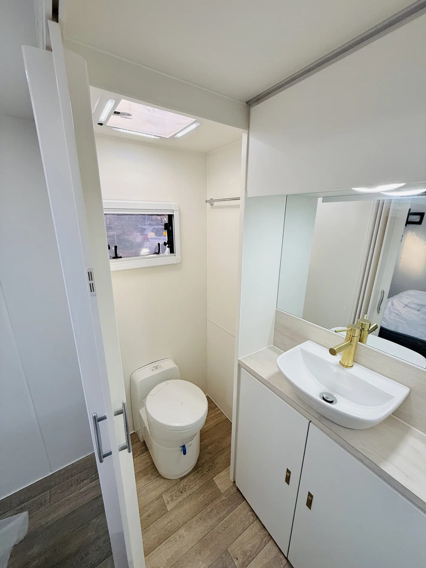 Sunstar ensuite bathroom with brass fittings, vanity and full-height shower