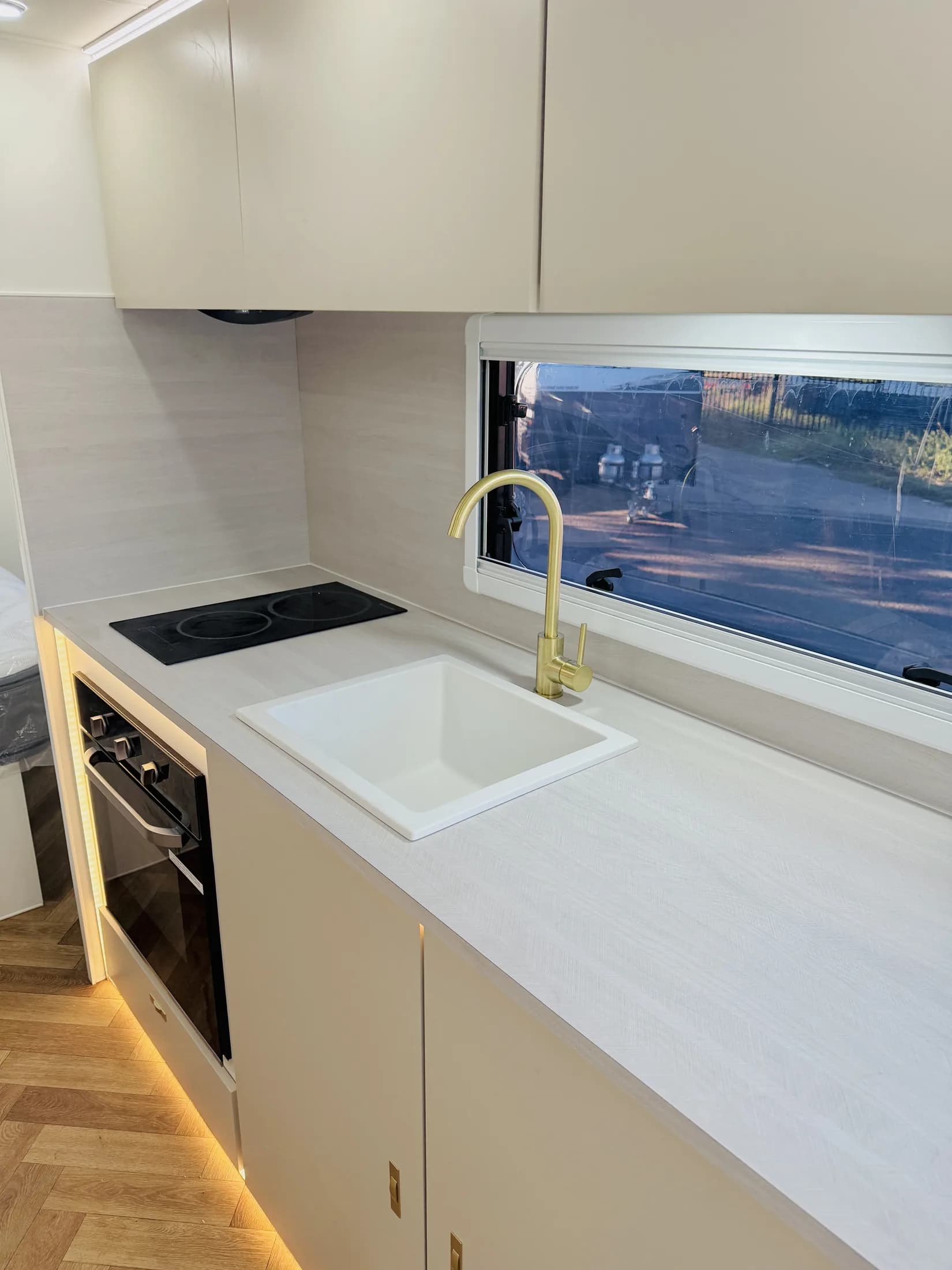 Sunstar flagship galley with brushed-brass tap, induction cooktop and stone benchtop